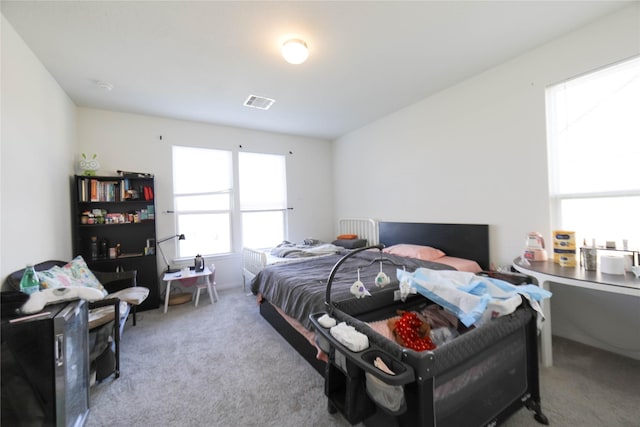 bedroom featuring light carpet