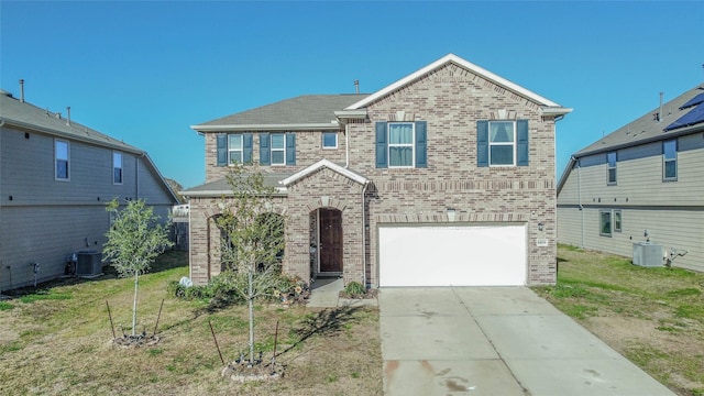 view of front of house with cooling unit, a garage, and a front yard