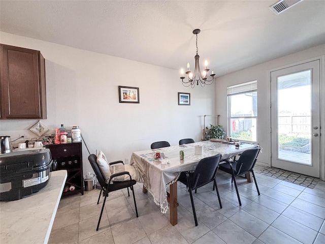 dining area featuring an inviting chandelier