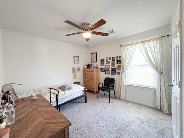 bedroom featuring ceiling fan and carpet