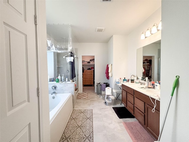 bathroom featuring vanity and shower with separate bathtub