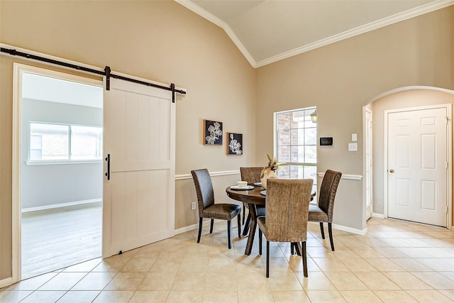 tiled dining area with crown molding, a barn door, high vaulted ceiling, and a wealth of natural light