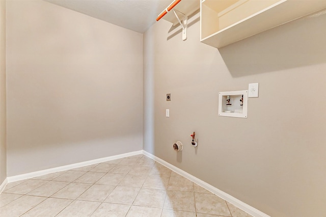 laundry area with tile patterned flooring, hookup for a gas dryer, hookup for a washing machine, and hookup for an electric dryer