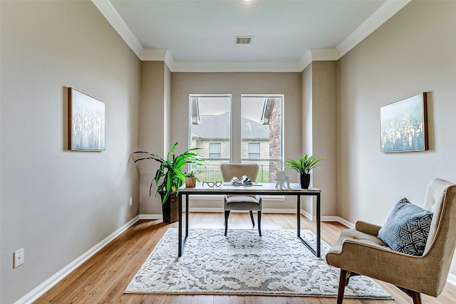 office area with ornamental molding and light hardwood / wood-style flooring