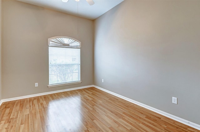 spare room with ceiling fan and light wood-type flooring