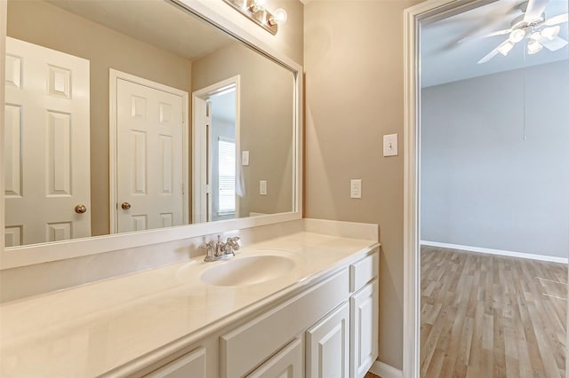 bathroom with vanity, hardwood / wood-style flooring, and ceiling fan