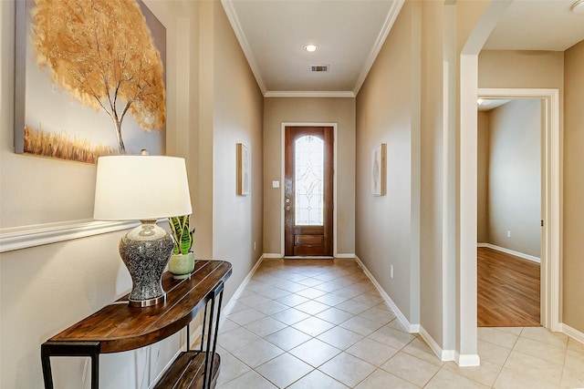 entrance foyer featuring light tile patterned flooring and ornamental molding