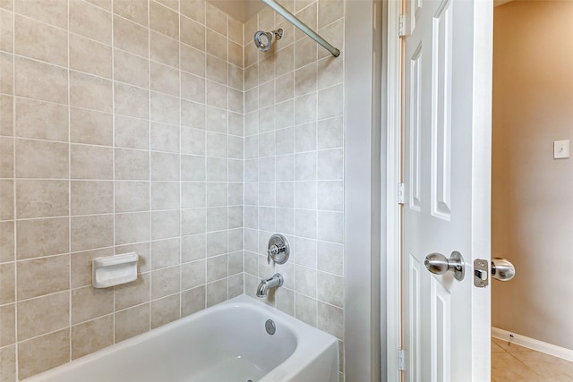 bathroom with tile patterned floors and tiled shower / bath