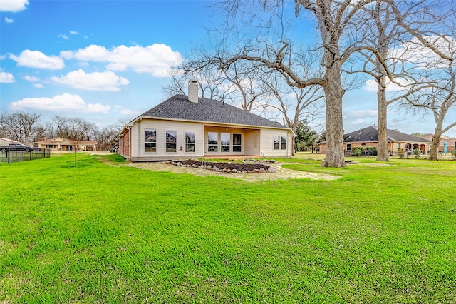 back of house featuring a lawn