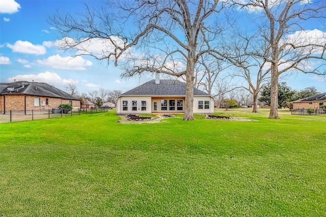 rear view of house with a lawn