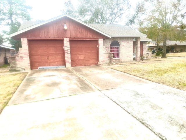 ranch-style house featuring a garage and a front lawn