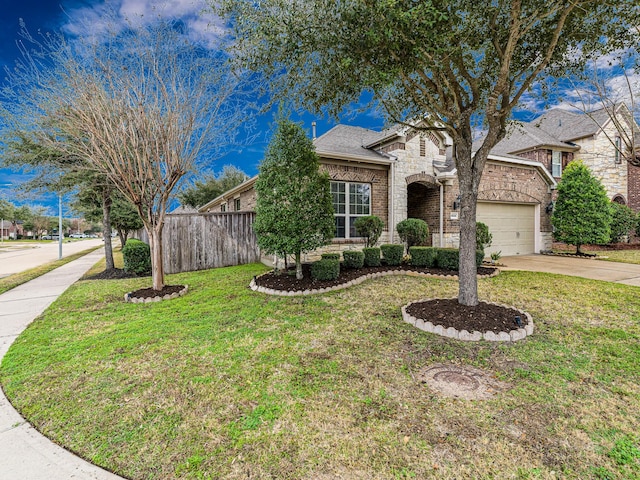 view of front of home with a garage and a front yard