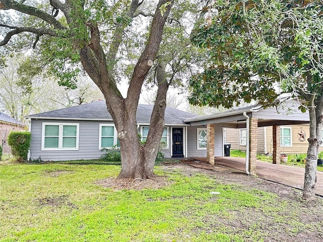 ranch-style house with a front yard and a carport