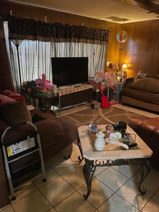 living room with tile patterned floors and wood walls