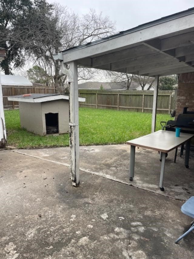 exterior space featuring a patio, a yard, and an outbuilding