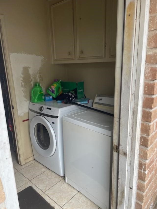 washroom featuring separate washer and dryer and light tile patterned floors