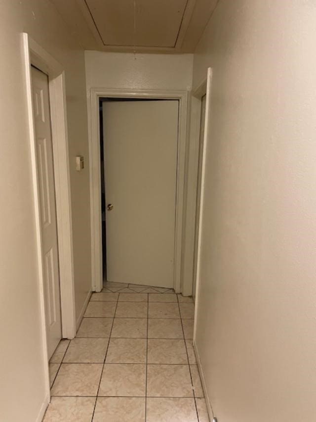 corridor with light tile patterned flooring