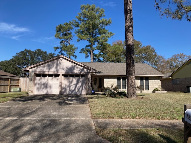 ranch-style home with a garage, central AC unit, and a front yard