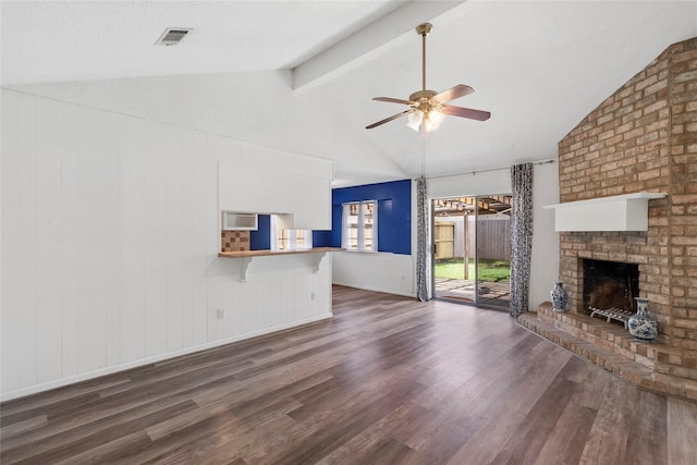 unfurnished living room featuring vaulted ceiling with beams, dark wood-type flooring, a fireplace, and ceiling fan