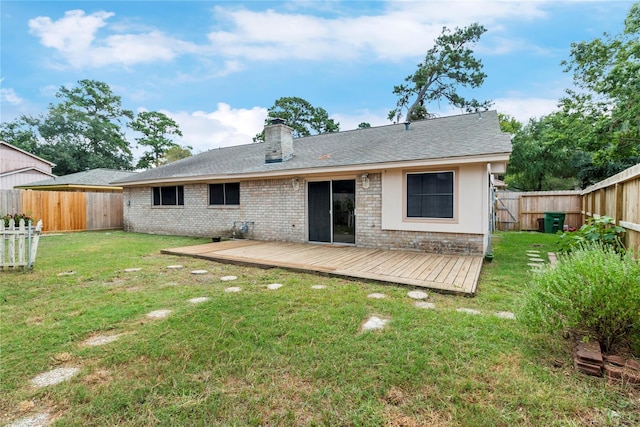 back of house featuring a wooden deck and a lawn