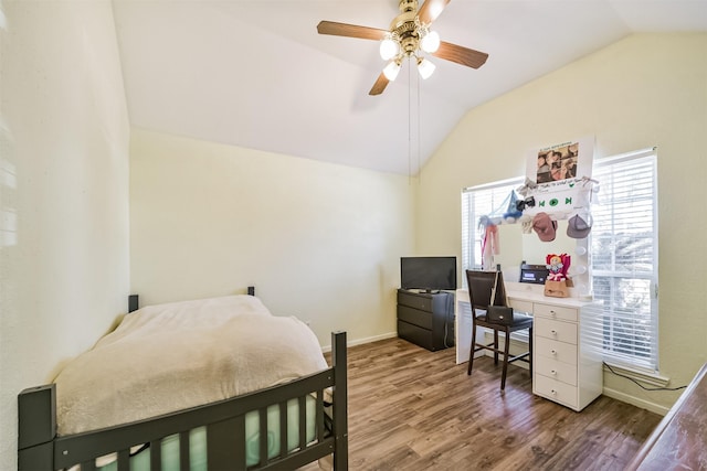 bedroom featuring lofted ceiling, wood finished floors, a ceiling fan, and baseboards