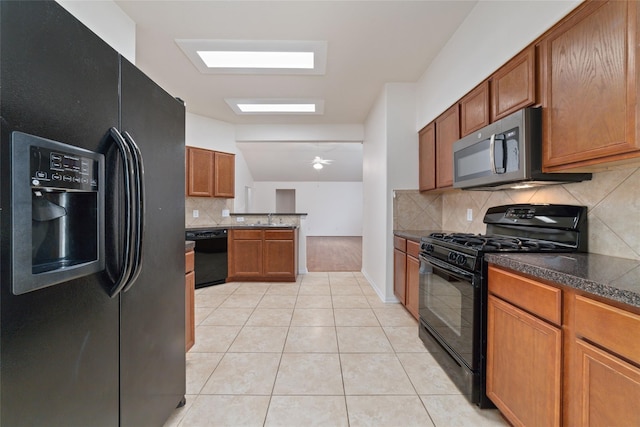 kitchen with sink, tasteful backsplash, light tile patterned floors, ceiling fan, and black appliances