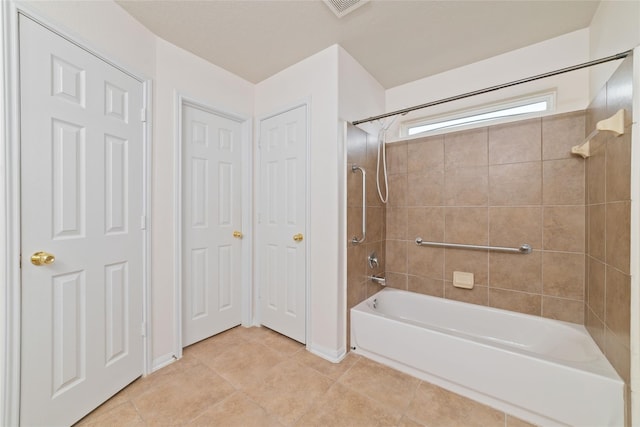 bathroom with tiled shower / bath combo and tile patterned floors