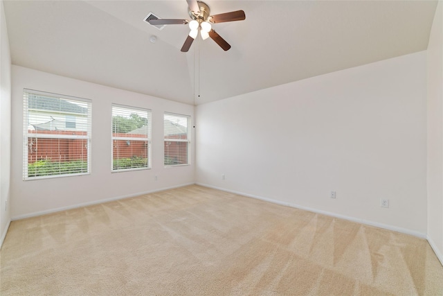 carpeted empty room featuring vaulted ceiling and ceiling fan