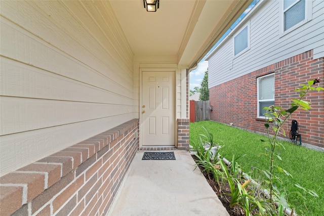 doorway to property featuring a yard