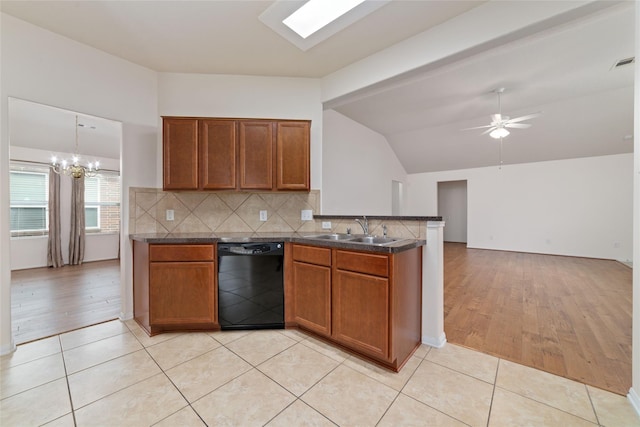 kitchen with pendant lighting, sink, light tile patterned floors, dishwasher, and ceiling fan with notable chandelier