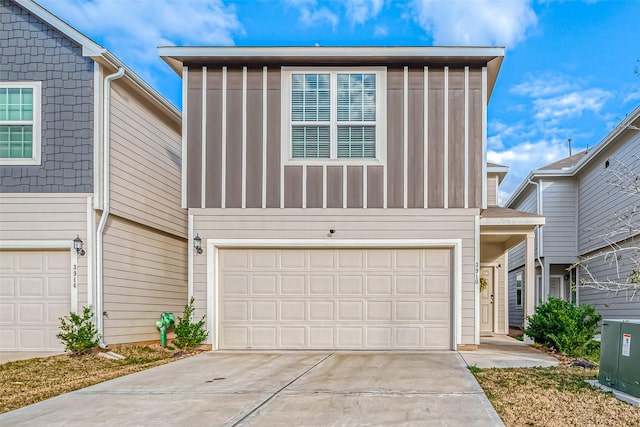 view of front of home featuring concrete driveway and an attached garage