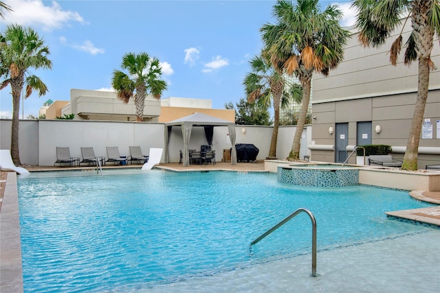 view of pool featuring a community hot tub, a water slide, a gazebo, a patio area, and area for grilling