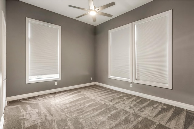 carpeted spare room with ceiling fan