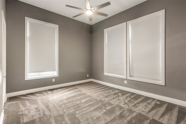 unfurnished room with carpet floors, baseboards, and ceiling fan