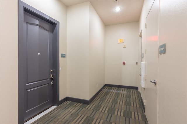 corridor with dark colored carpet