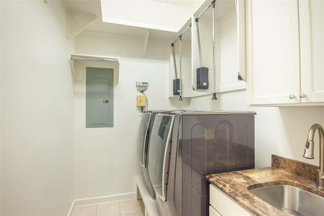 clothes washing area featuring cabinet space, independent washer and dryer, a sink, and electric panel
