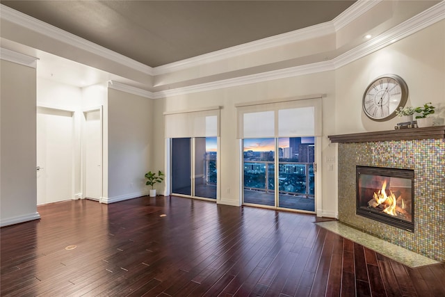 unfurnished living room featuring ornamental molding, wood-type flooring, and a fireplace