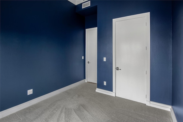 unfurnished bedroom with baseboards, carpet flooring, and visible vents