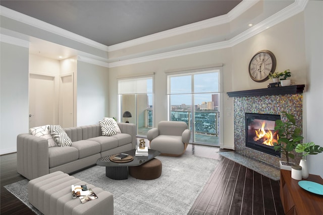 living room with hardwood / wood-style flooring, crown molding, a raised ceiling, and a fireplace