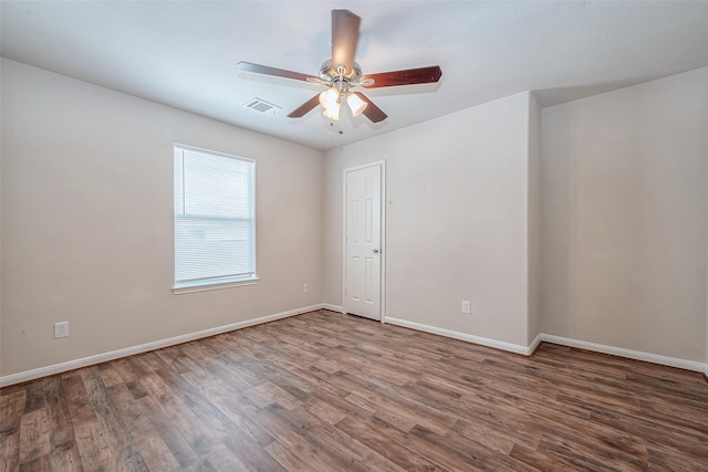 empty room featuring dark hardwood / wood-style flooring and ceiling fan