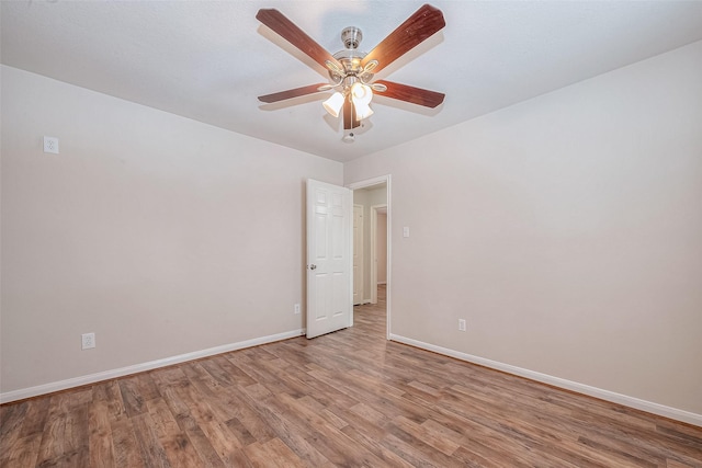 unfurnished room with ceiling fan and hardwood / wood-style floors