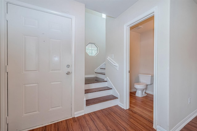 staircase with hardwood / wood-style flooring