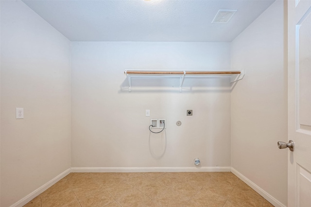 washroom featuring gas dryer hookup, hookup for an electric dryer, hookup for a washing machine, and light tile patterned floors