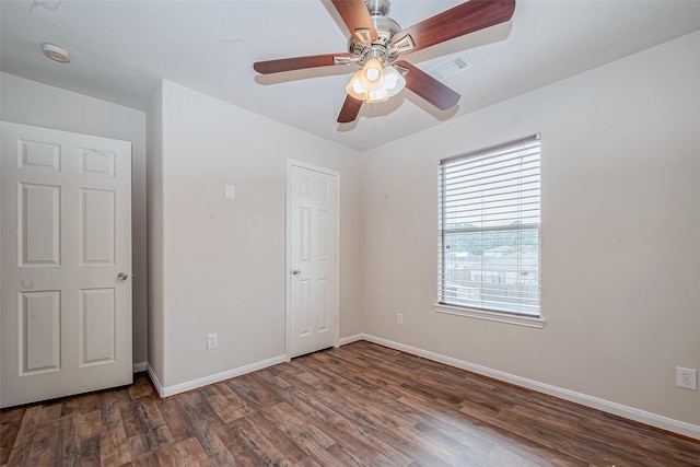 unfurnished bedroom featuring ceiling fan and dark hardwood / wood-style flooring