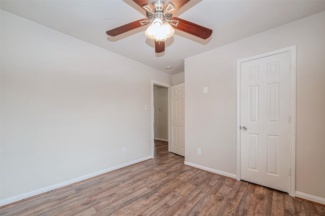 unfurnished bedroom featuring hardwood / wood-style floors and ceiling fan