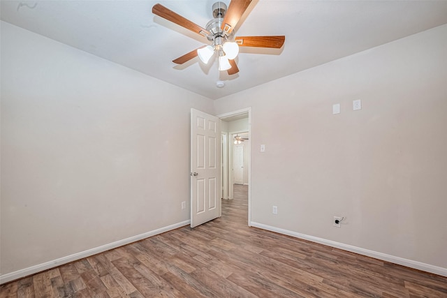 empty room featuring hardwood / wood-style floors and ceiling fan