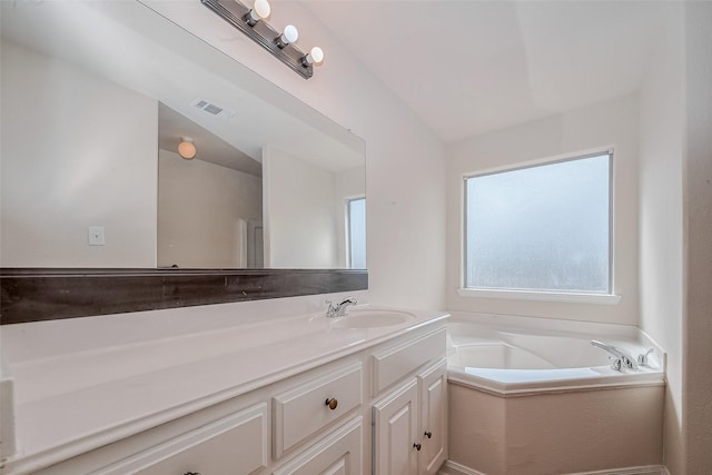 bathroom featuring vanity and a tub