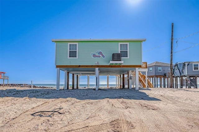 rear view of house featuring a water view