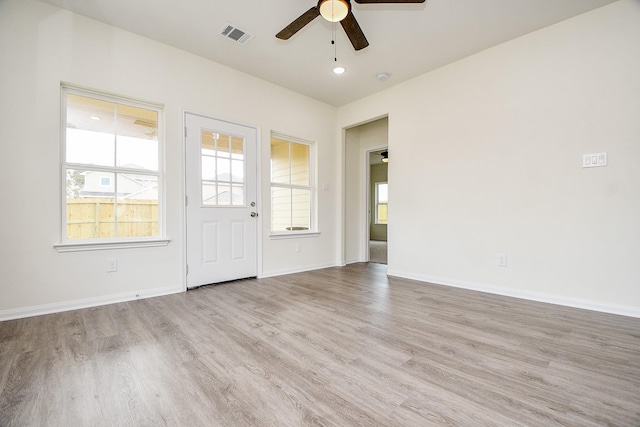 spare room with ceiling fan and light hardwood / wood-style flooring