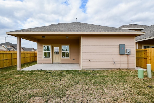 rear view of house featuring a patio and a yard